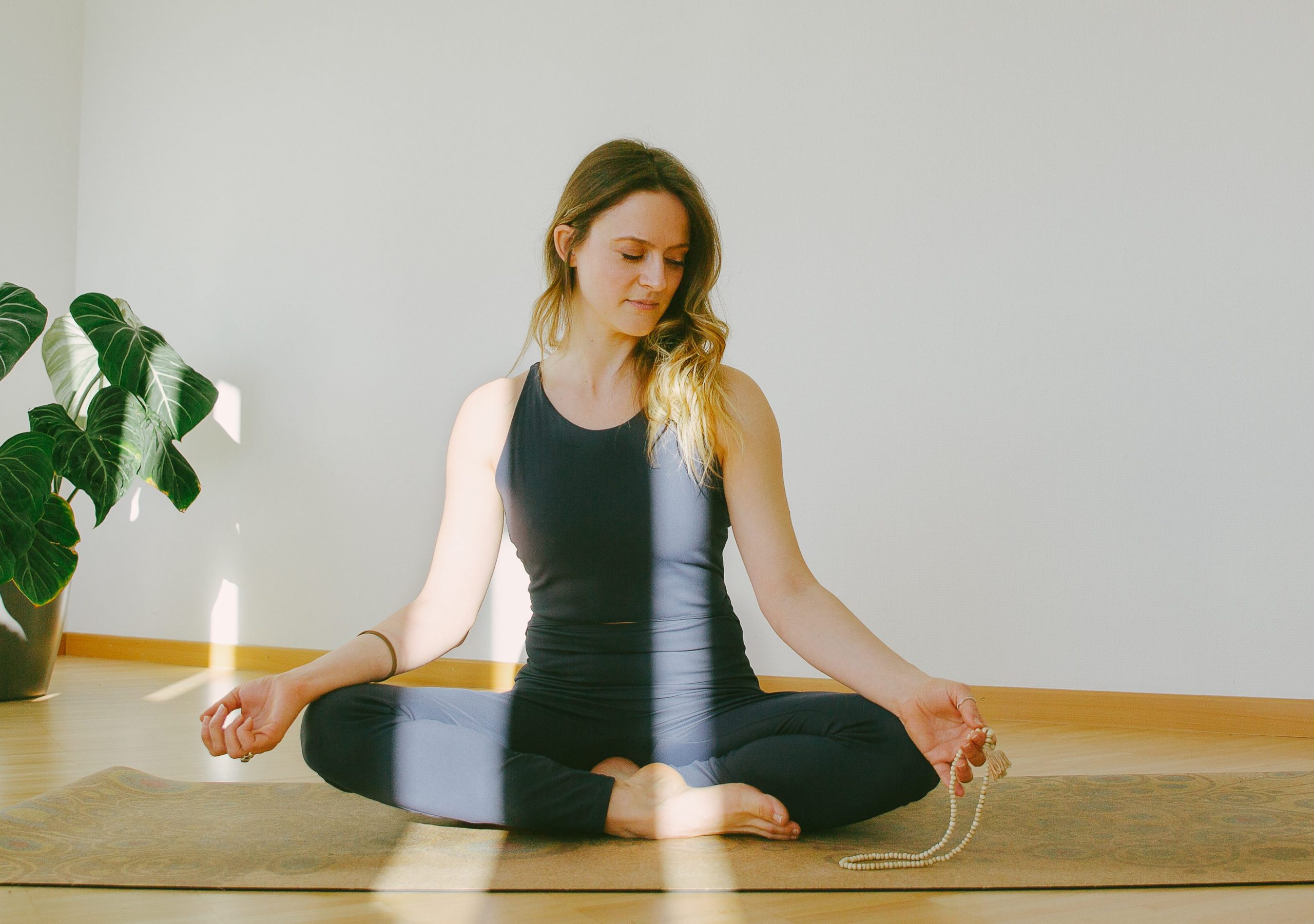 Crossed leg with a mala on my left hand resting on the knee